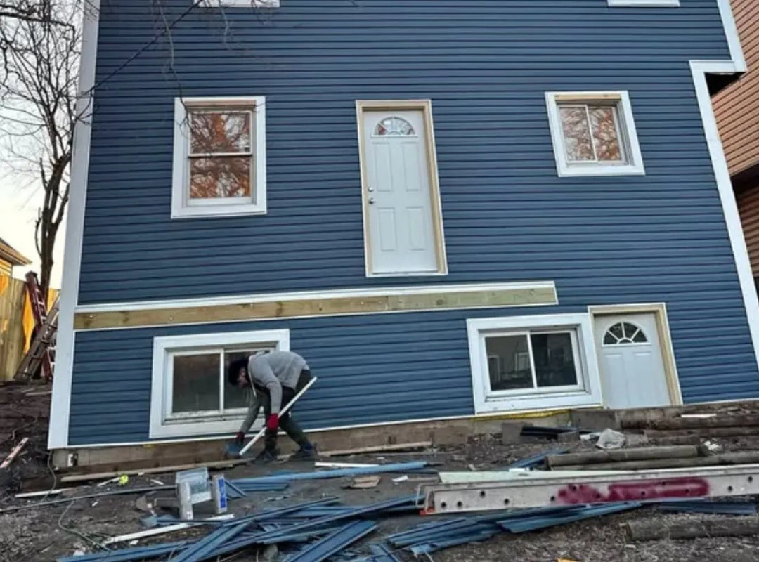 Blue lap siding installation in progress on an Eau Claire, WI home